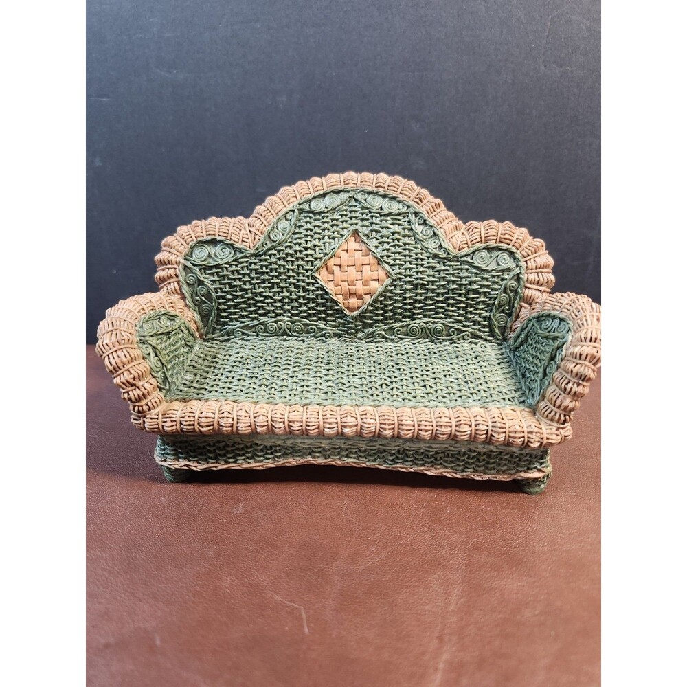 miniature resin dollhouse sofa with a faux wicker and rattan texture.